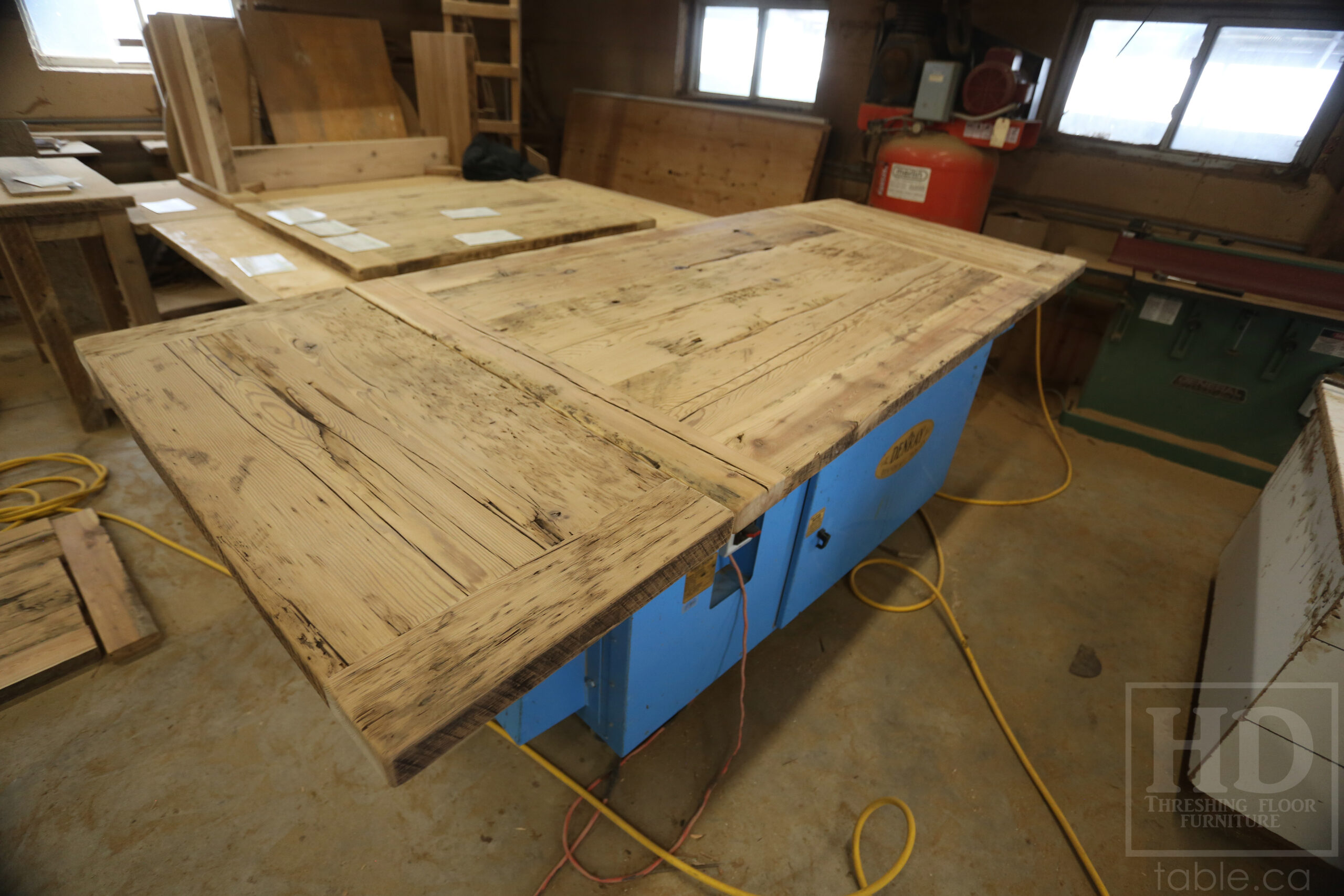 5.5â€™ Ontario Barnwood Table we made for a Dundas, Ontario Home â€“ 40â€ wide â€“ Matte Black X Shaped Base â€“ Skirting + Drawer Option - Old Growth Reclaimed Hemlock Threshing Floor Construction â€“ Original edges & distressing maintained - Premium epoxy + satin polyurethane finish â€“ Two 18â€ leaves - www.table.ca