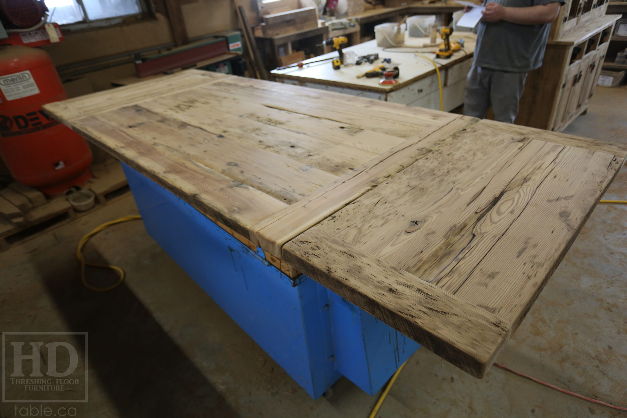 5.5â€™ Ontario Barnwood Table we made for a Dundas, Ontario Home â€“ 40â€ wide â€“ Matte Black X Shaped Base â€“ Skirting + Drawer Option - Old Growth Reclaimed Hemlock Threshing Floor Construction â€“ Original edges & distressing maintained - Premium epoxy + satin polyurethane finish â€“ Two 18â€ leaves - www.table.ca