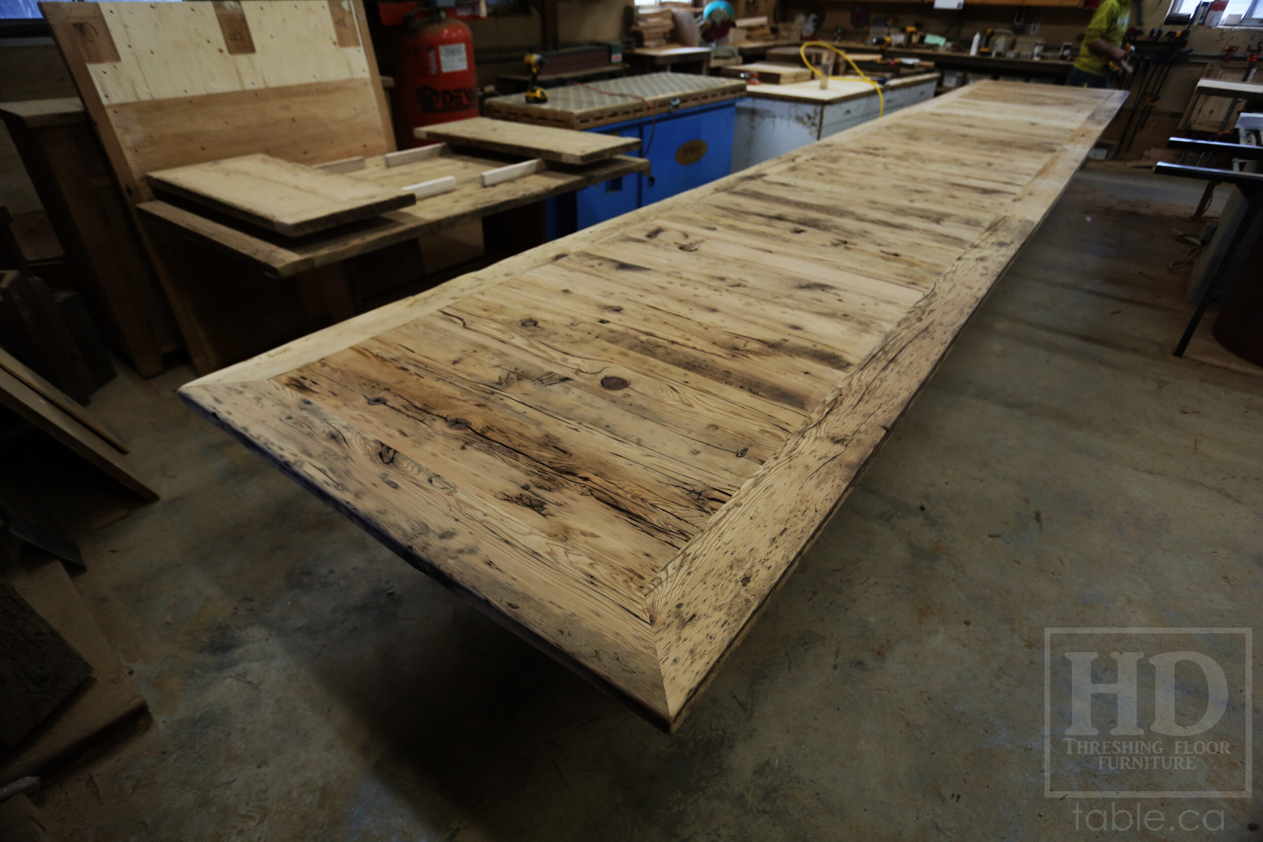 24 Ft Ontario Barnwood Table we made for a Guelph, Ontario company - 48" wide â€“ [3] 8' Sections [on site final doweling] - 3" Joist Plank Posts Base - Reclaimed Hemlock Threshing Floor 2â€ Top - Original edges & distressing maintained - Premium epoxy + satin polyurethane finish - www.table.ca