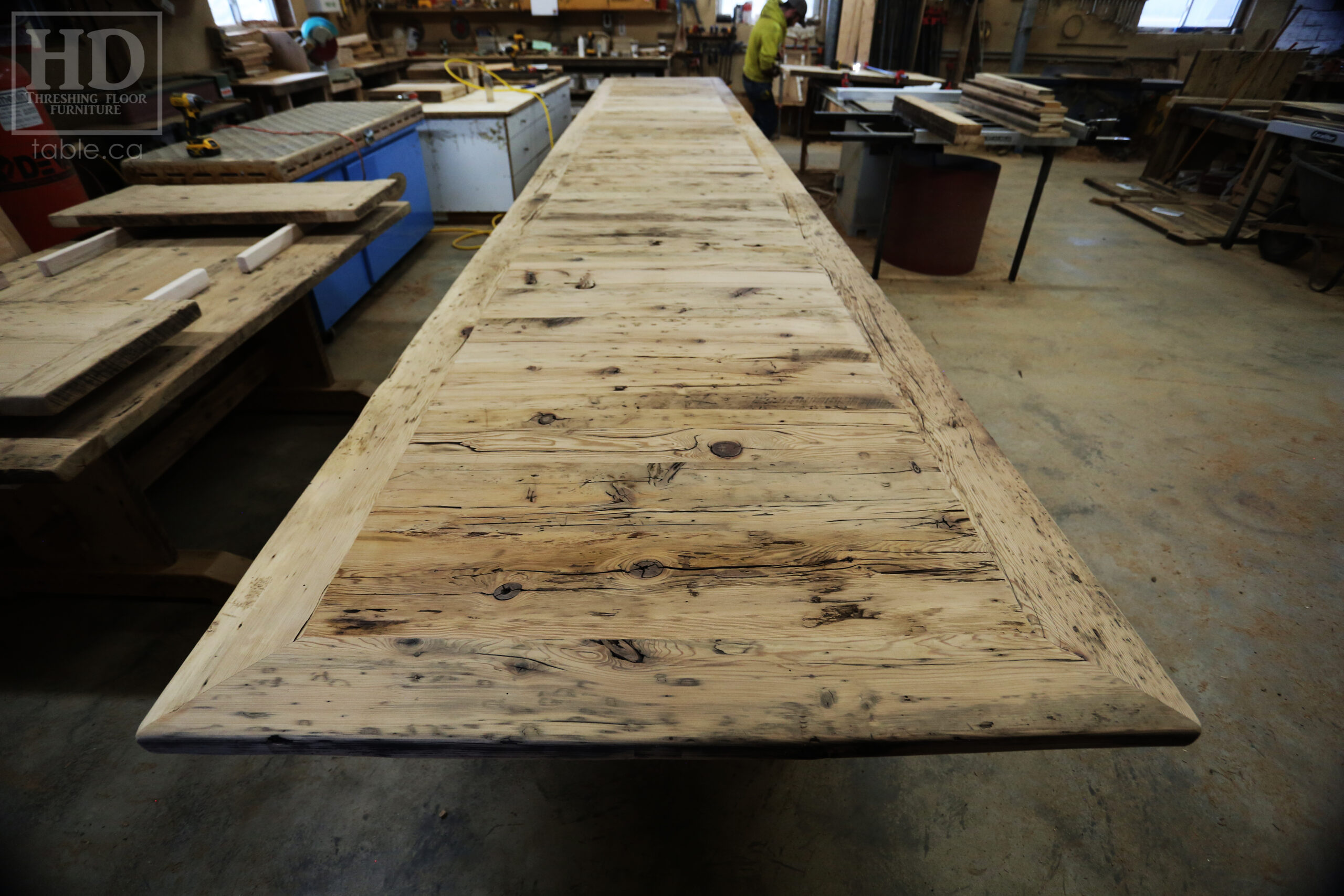 24 Ft Ontario Barnwood Table we made for a Guelph, Ontario company - 48" wide â€“ [3] 8' Sections [on site final doweling] - 3" Joist Plank Posts Base - Reclaimed Hemlock Threshing Floor 2â€ Top - Original edges & distressing maintained - Premium epoxy + satin polyurethane finish - www.table.ca