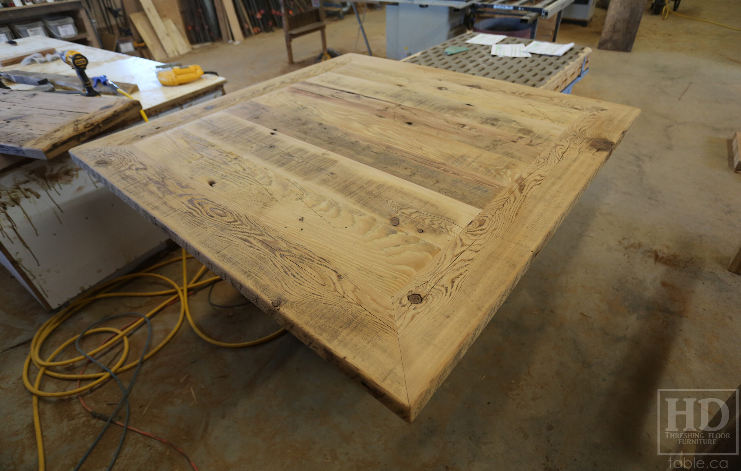 50" x 50" Ontario Barnwood Table we made for a Toronto Company - X Shaped Metal Base - Mitred Corners - Reclaimed Old Growth Hemlock Threshing Floor Construction - Original edges & distressing maintained - Premium epoxy + satin polyurethane finish  - One 18" Leaf Extension - www.table.ca