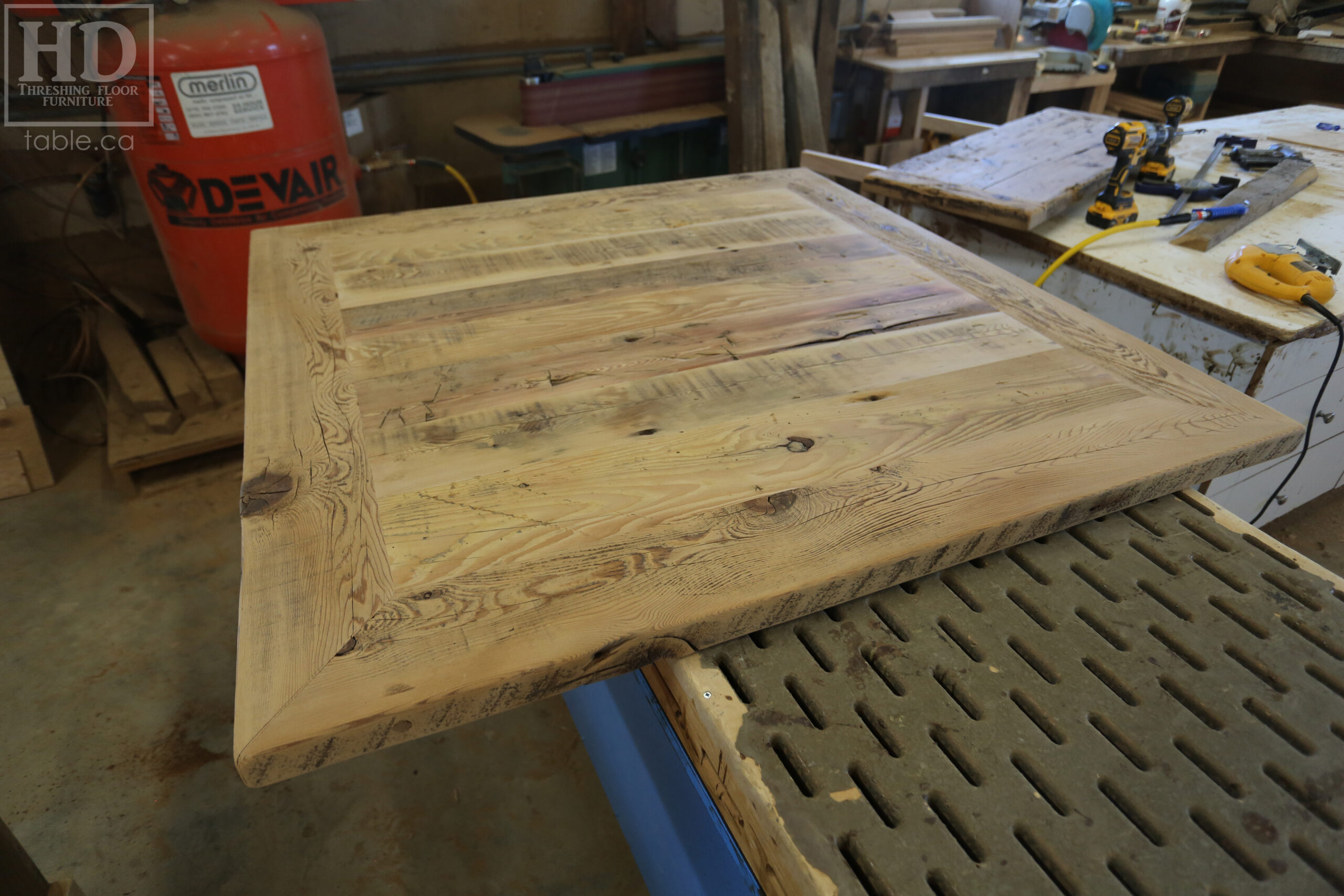 50" x 50" Ontario Barnwood Table we made for a Toronto Company - X Shaped Metal Base - Mitred Corners - Reclaimed Old Growth Hemlock Threshing Floor Construction - Original edges & distressing maintained - Premium epoxy + satin polyurethane finish  - One 18" Leaf Extension - www.table.ca