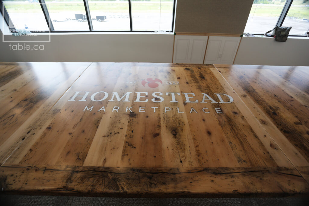 17' Reclaimed Ontario Barnwood Table we made for a Quinte West marketplace - 6' Wide - Extra thick 3" Top Option - Hand Hewn Beam Pedestals Base - Old Growth Hemlock Threshing Floor Construction - Original edges & distressing maintained - Premium epoxy + satin polyurethane finish - Custom Metal Graphic Logo Embedded - Greytone Option - 3 part on site final doweling option - www.table.ca