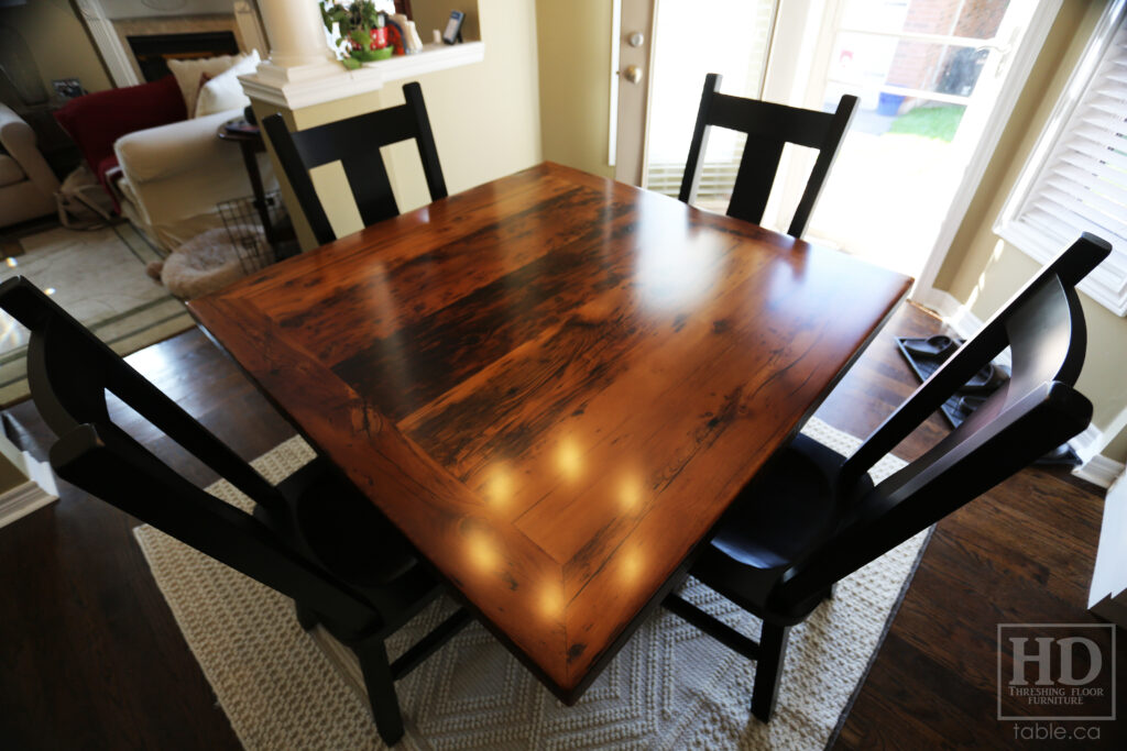 48" x 48" Ontario Barnwood Table we made for an Oakville home - Hand-Hewn Pedestal Post - Old Growth Reclaimed Hemlock Threshing Floor Construction - Original edges & distressing maintained - Premium epoxy + satin polyurethane finish - 4 Plank Back Chairs / Wormy Maple / Painted Solid Black - www.table.ca