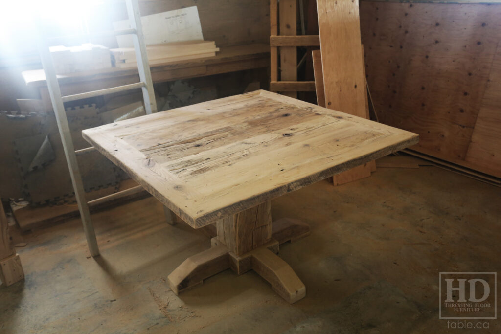 48" x 48" Ontario Barnwood Table we made for an Oakville home - Hand-Hewn Pedestal Post - Old Growth Reclaimed Hemlock Threshing Floor Construction - Original edges & distressing maintained - Premium epoxy + satin polyurethane finish - 4 Plank Back Chairs / Wormy Maple / Painted Solid Black - www.table.ca